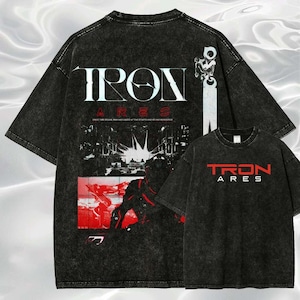 May include: Black oversized t-shirts with the text "TRON ARES" in red and white. The back of the shirt features a graphic design with the text "IRON ARES" and a futuristic cityscape in black and red.