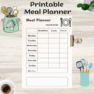 May include: Printable meal planner with a minimalist design. The white paper features a grid for daily meal planning, with sections for breakfast, lunch, and dinner. The text "Meal Planner" is at the top, with the phrase "KALE ME MAYBE" below it.