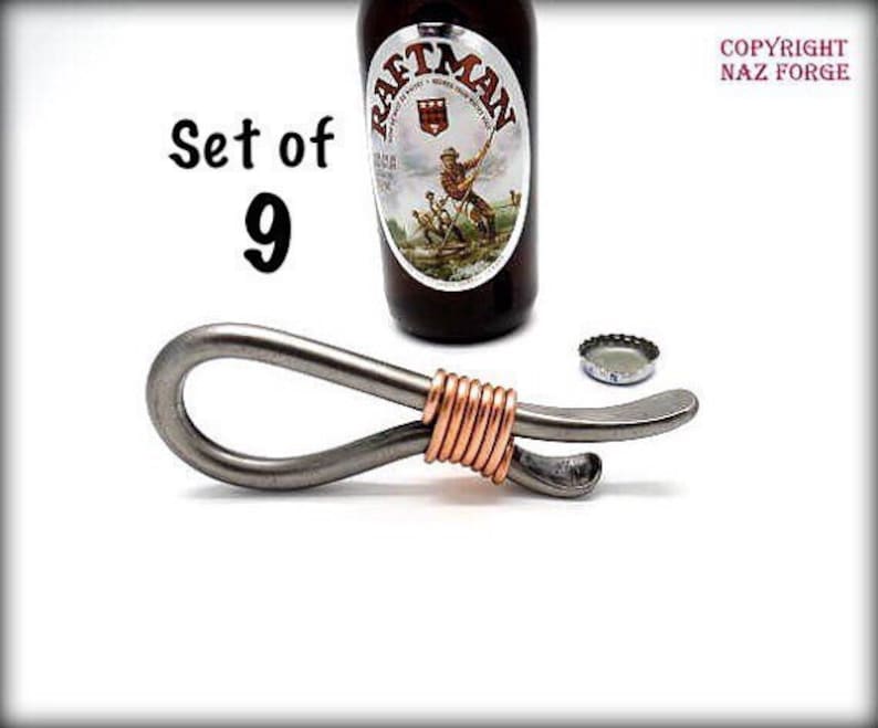 May include: Set of 9 silver bottle openers with copper wire accents. The bottle openers are shaped like a loop with a small hook on the end.
