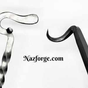 May include: Two metal fireplace tools with a hook on the end. The tool on the left is twisted and silver in color. The tool on the right is straight and black.