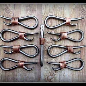May include: Ten metal bottle openers with copper wire wrapped handles. The openers are shaped like a figure eight and have a bottle opener on one end.