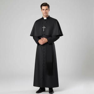 Może przedstawiać: Czarna sutanna duchowna z pasującą peleryną i srebrnym wisiorkiem z krzyżem. Długi rękaw odzieży posiada zapięcie na guziki z przodu i czarny pas z frędzlami. Kołnierz jest biały.