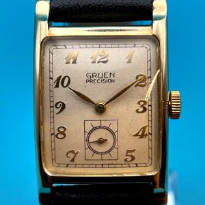 May include: A set of three ceramic mugs with a speckled, matte finish. The mugs are in shades of cream, light gray, and dark gray. Each mug has a simple, minimalist design, perfect for coffee or tea.