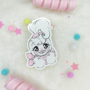 May include: White and pink cartoon character with large eyes and a bow. The character is wearing a pink bow and has a white fluffy tail. The character is smiling and has its paws up.