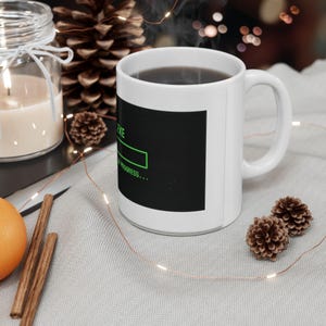 May include: A set of three ceramic mugs with a speckled, matte finish. The mugs are in shades of cream, light gray, and dark gray. Each mug has a simple, minimalist design, perfect for coffee or tea.