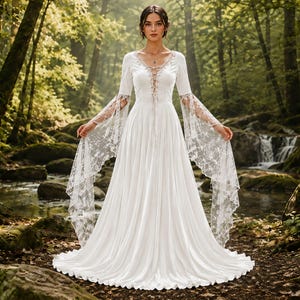 May include: A floor-length white dress featuring long, flared lace sleeves, a V-neckline with a lace-up corset-style bodice, and a flowing skirt. The garment is constructed with solid white fabric on the bodice and skirt, contrasted by intricate white floral lace detailing on the sleeves and neckline.