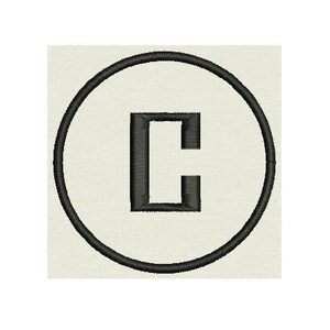 May include: Black and white embroidered letter C in a circle.