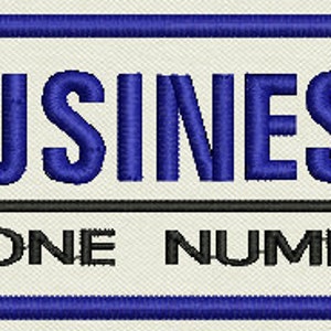 May include: A white rectangular sign with a blue border. The text "BUSINESS PHONE NUMBER" is printed in black.