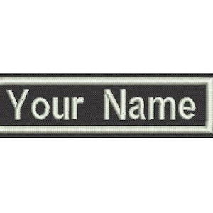 May include: Black and white embroidered patch with the text "Your Name" in a white font.