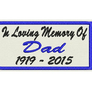 May include: A white rectangular patch with a blue border. The text "In Loving Memory Of Dad 1919 - 2015" is embroidered in black and blue.