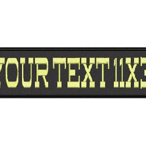 May include: Black rectangular patch with the text "YOUR TEXT 11X3" in yellow.