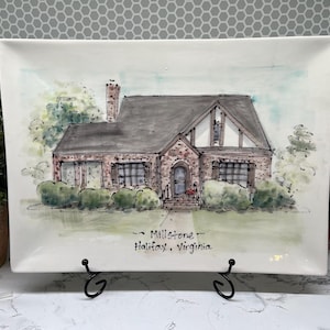 May include: Rectangular ceramic serving platter with a hand-painted illustration of a house. The house has a brick facade, a gray roof, and is surrounded by green bushes and trees. The text "Millstone, Halifax, Virginia" is written below the house.