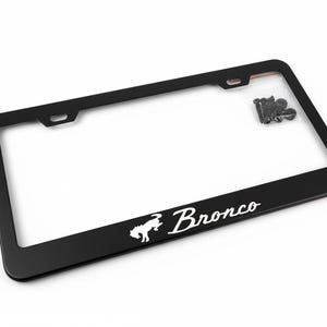 May include: Black license plate frame with the word "Bronco" in white script and a white horse logo. The frame has a rectangular shape with rounded corners and includes mounting hardware.