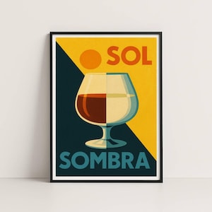Puede incluir: Un póster enmarcado con una ilustración estilizada de una copa de brandy, dividida verticalmente con líquidos oscuros y claros. La palabra "SOL" está encima de la copa y "SOMBRA" debajo. El fondo es amarillo, azul marino y naranja.