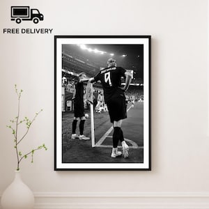 May include: A black and white framed wall art print depicting a soccer player wearing a jersey with the number 9 and the name Haaland on the back, standing on a field near a corner flag, with another player visible in the background.