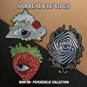 May include: Three embroidered iron-on patches with eye designs. One patch is a strawberry with an eye, another is an eye within a triangle, and the third is an eye in a decorative frame. The text "SURREAL EYE VIBES" and "IRON-ON • PSYCHEDELIC COLLECTION" are also visible.