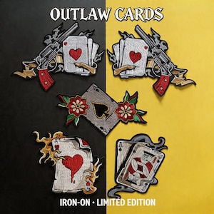 May include: Embroidered patches featuring playing cards, revolvers, and floral accents. The patches include the text "OUTLAW CARDS" and "IRON-ON - LIMITED EDITION". The designs incorporate hearts, spades, and decorative elements.