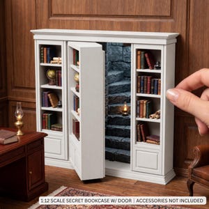 May include: A 1:12 scale white wooden bookcase featuring a secret swinging door that reveals a stone staircase. The unit has multiple shelves filled with miniature books, scrolls, and a globe. The text 1:12 SCALE SECRET BOOKCASE W/ DOOR | ACCESSORIES NOT INCLUDED is visible.