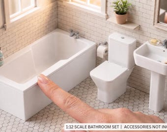 May include: A 1:12 scale miniature bathroom set featuring a white bathtub, a white toilet, and a white pedestal sink. The set includes a small potted plant, a mirror, a bottle, a sponge, and a towel. Text on the image reads 1:12 SCALE BATHROOM SET | ACCESSORIES NOT INCLUDED.