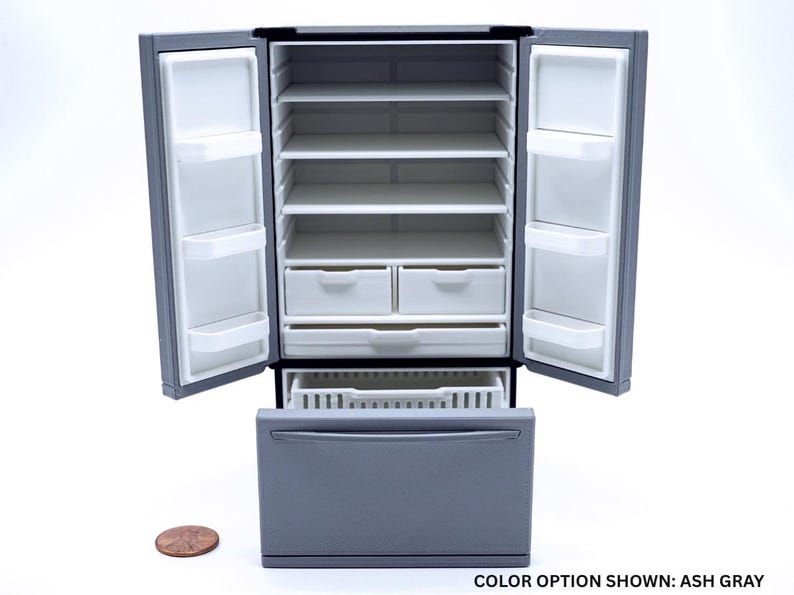 May include: An ash gray miniature refrigerator with two open doors, four interior shelves, two small drawers, and one large bottom pull-out drawer. A copper penny is placed to the left for scale, and the text reads: COLOR OPTION SHOWN: ASH GRAY.