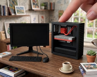 May include: A miniature 1:12 scale computer set featuring a black monitor, a black keyboard, a black mouse, and a black computer tower case with visible internal red and grey components. The text 1:12 SCALE COMPUTER, MONITOR, KEYBOARD & MOUSE | ACCESSORIES NOT INCLUDED is printed at the bottom.