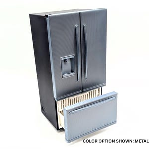 May include: A metallic gray refrigerator with a black side panel, two vertical doors, and a bottom freezer drawer. The unit features a water dispenser on the left door and includes the text COLOR OPTION SHOWN: METALLIC GRAY at the bottom right.