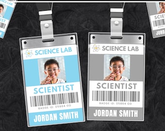 May include: Two science lab ID badges with the text "SCIENCE LAB" and "SCIENTIST". One badge has a light blue background, the other is gray. Both include a photo, barcode, and the name "JORDAN SMITH". The top text reads "EDITABLE TEMPLATE".