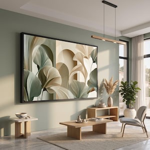 May include: A large rectangular wall art piece in a black frame featuring an abstract composition of flowing, layered leaf-like shapes in soft shades of sage green, cream, and beige, set against a background of architectural archways.