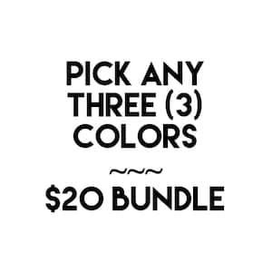 May include: A set of three ceramic mugs with a speckled, matte finish. The mugs are in shades of cream, light brown, and dark brown. Each mug has a simple, minimalist design and a rounded handle.