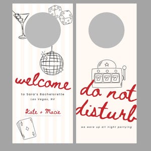May include: Set of two door hangers with a Las Vegas theme. One says "welcome" with a martini, disco ball, and playing cards. The other says "do not disturb" with a slot machine. Both have a blank circle for a photo.