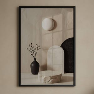 May include: A framed art print featuring a minimalist still life with a black vase holding delicate branches. The artwork includes a white sphere, arch, and a stone-like pedestal. The bed below has tan pillows and a beige comforter.