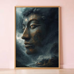 May include: A framed art print featuring a detailed side profile of a Buddha statue. The artwork showcases a weathered bronze-like face with a serene expression, set against a backdrop of mountains, clouds, and lightning. The frame is gold.