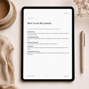 May include: A digital tablet displaying a journal page with the title "How to use this journal." The page lists practices like Daily Reset, Overthinking Breakdown, and Emotional Clarity Pages. A pen and a cup of coffee are on the table.