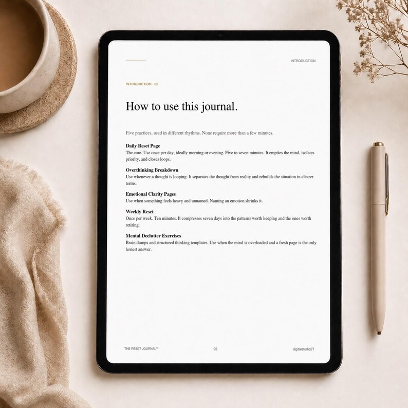 May include: A digital tablet displaying a journal page with the title "How to use this journal." The page lists practices like Daily Reset, Overthinking Breakdown, and Emotional Clarity Pages. A pen and a cup of coffee are on the table.