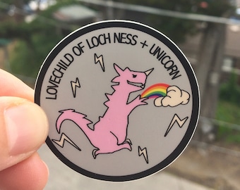 Lochness Unicorn Lovechild sticker, dinosaur, sticker, pink dinosaur, rainbow, lightning, thunder, queer, lgbtq, lgbt, stickers, laptop