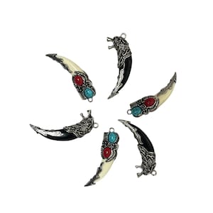 May include: Six curved tooth-shaped pendants arranged in a circle. Each pendant features a silver-toned metal cap with intricate detailing, inlaid with one oval red stone and one oval turquoise stone, attached to a small metal jump ring loop.