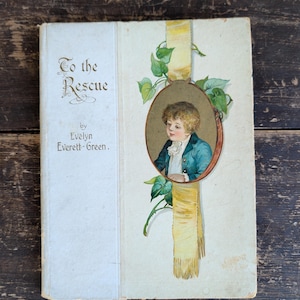 May include: A vintage hardcover book titled To the Rescue by Evelyn Everett-Green. The off-white cover features a central oval illustration of a child in a blue jacket and white ruff, framed by a yellow ribbon and green ivy leaves.