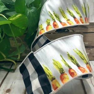 May include: White ribbon with a repeating pattern of watercolor carrots with green tops and orange bodies. The ribbon has a black and white checkered pattern on the reverse side. The ribbon is used for crafts and decorations.