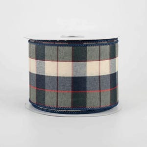 May include: A spool of decorative ribbon with a plaid pattern in shades of navy, green, cream, and red. The ribbon has a dark blue stitched edge. This ribbon is suitable for crafts, gift wrapping, and seasonal decor.
