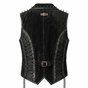May include: Black vest with a velvet texture, leather trim, and lace-up sides. The vest features a decorative buckle, metal spikes on the collar, and a patterned fabric insert. A gothic or punk style.