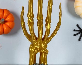 Ringhouder in de vorm van een skelethand – Glanzend gouden gotische sieradenstandaard