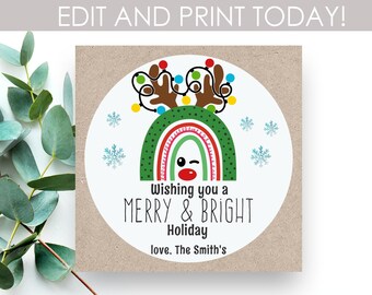 May include: A round, white gift tag with a green, red, and yellow rainbow with a reindeer face on top. The reindeer has a red nose and is winking. The tag has the text "Wishing you a Merry & Bright Holiday love. The Smith's".