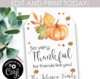 May include: A printable Thanksgiving gift tag featuring a watercolour illustration of a pumpkin and autumn leaves. The text reads "So very Thankful for friends like you! The Johnson Family".