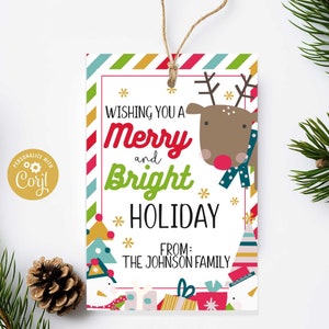 May include: A white gift tag with a red and green striped border. The tag features a cartoon reindeer with a red nose and a blue scarf. The text on the tag reads "Wishing you a Merry and Bright Holiday" and "From: The Johnson Family".