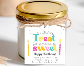 May include: A white gift tag with colorful text that reads "a birthday Treat for someone so sweet Happy Birthday!"  The tag is tied with twine to a clear glass jar with a gold lid. The text also includes "I hope your day is as wonderful as you are! love, Jessica Johnson"