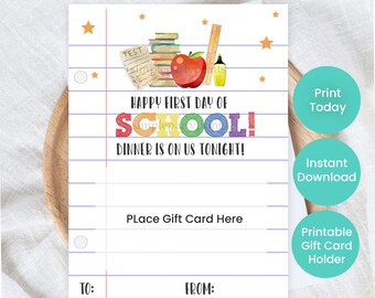 May include: A printable gift card holder with a school theme. The design features a stack of books, a red apple, and the text "HAPPY FIRST DAY OF SCHOOL! DINNER IS ON US TONIGHT!" on a lined paper background.
