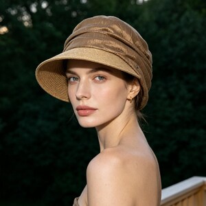 May include: A stylish brown hat with a brim, featuring a textured crown and a contrasting woven brim. The hat is designed for sun protection and adds a touch of elegance. Perfect for outdoor activities.