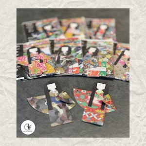 May include: A selection of colourful paper dolls and packaged sets. The dolls feature traditional Japanese kimono designs with black hair and white faces. The packaging displays similar doll illustrations. The Getfun Garden logo is visible.