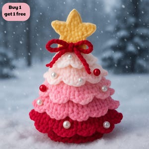 May include: A handcrafted crochet Christmas tree in red, pink, and white, with a yellow star and a red bow. It features white pearl beads and red ball ornaments. The text "Buy 1 get 1 free" is in the upper left corner of the image.