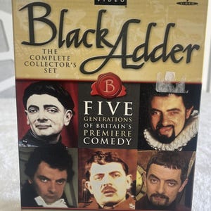 May include: The Black Adder The Complete Collector's Set DVD box set features a tan cover with the title in black script. It displays five photographic portraits of Rowan Atkinson in various historical costumes, with the text Five Generations of Britain's Premiere Comedy and BBC Video branding.